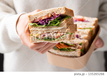 Sandwich tuna mayonnaise with whole wheat bread, lettuce, carrot, tomato and purple cabbage 135265266