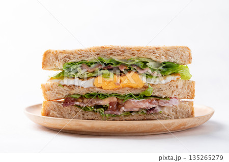 Whole wheat bread sandwich with bacon, lettuce, tomato and fried egg 135265279