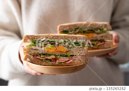 Whole wheat bread sandwich with bacon, lettuce, tomato and fried egg 135265282