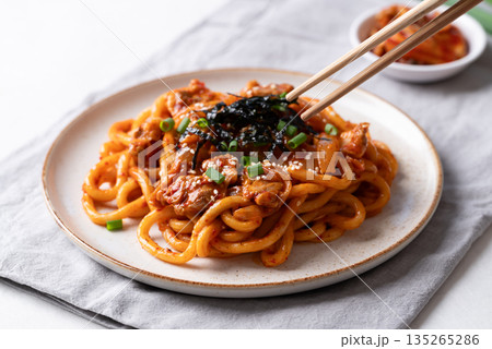 Stir fried Udon noodle with kimchi cabbage, pork, spring onion, sesame seed and seaweed on top Stir fried Udon noodle with kimchi cabbage, pork, spring onion, sesame seed and seaweed on top 135265286