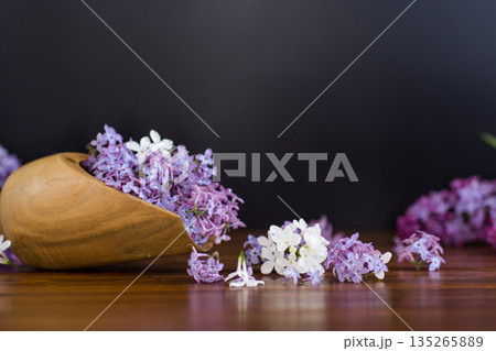 Beautiful spring lilac on wooden table in scoop 135265889