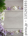 Flower frame of white and purple lilac on light wooden background 135265893