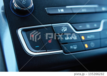 Car seat heating and climate control buttons close up 135266282