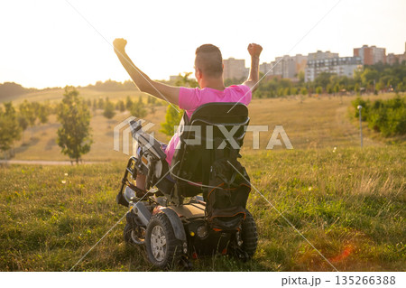 Emotional lifestyle portrait of a man in a wheelchair enjoying life and feeling proud and fulfilled. 135266388