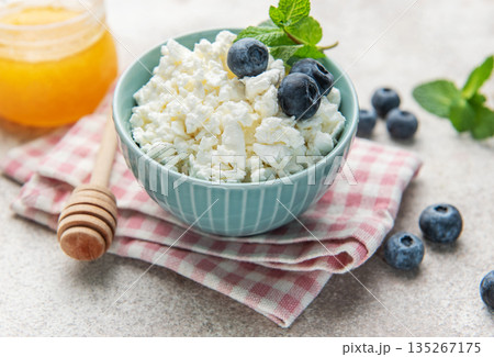 Cottage cheese bowl with fresh blueberries and honey 135267175