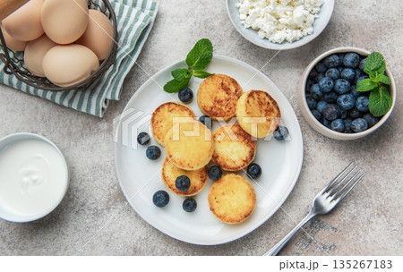 Syrniki cottage cheese pancakes with fresh blueberries and mint breakfast Syrniki cottage cheese pancakes with fresh blueberries and mint breakfast 135267183