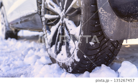 Car tires covered with snow and ice, harsh climatic conditions, operation of vehicles in winter, the condition of winter tires, features of driving in winter conditions, visualization of difficult Car tires covered with snow and ice, harsh climatic conditions, operation of vehicles in winter, the condition of winter tires, features of driving in winter conditions, visualization of difficult 135267457