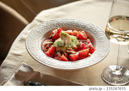 Fresh tomato salad with soft cheese in bowl Fresh tomato salad with soft cheese in bowl 135267635