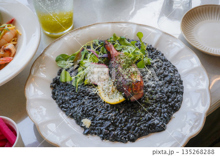 Squid Ink Risotto Topped with Grilled Calamari 135268288