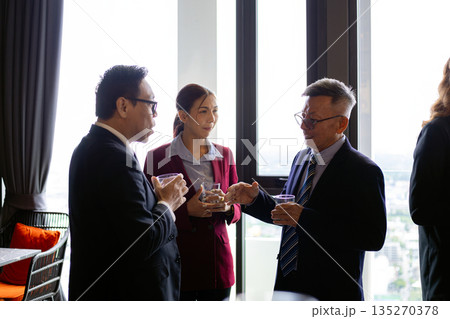 Group of business professionals talking and networking during corporate event in high-rise office, representing professional communication, leadership, and workplace connection Group of business professionals talking and networking during corporate event in high-rise office, representing professional communication, leadership, and workplace connection 135270378