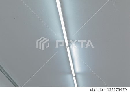 Fluorescent Light Illuminating Ceiling with Copy Space for Text, Graphics, or Logos for Commercial Interior Design Applications Fluorescent Light Illuminating Ceiling with Copy Space for Text, Graphics, or Logos for Commercial Interior Design Applications 135273479