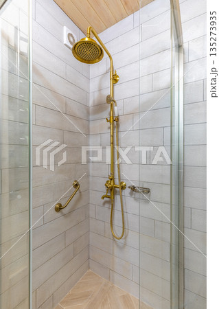 Vintage brass shower set in a rustic bathroom interior 135273935