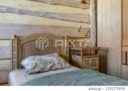 Traditional rustic bedroom with folk art bed and log wall decor Traditional rustic bedroom with folk art bed and log wall decor 135273939