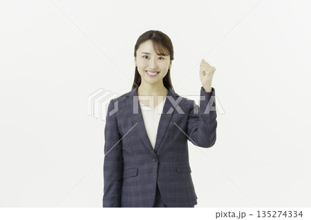 白背景の指さしポーズをするカメラ目線のスーツを着た若い日本人女性のポートレート 白背景の指さしポーズをするカメラ目線のスーツを着た若い日本人女性のポートレート 135274334