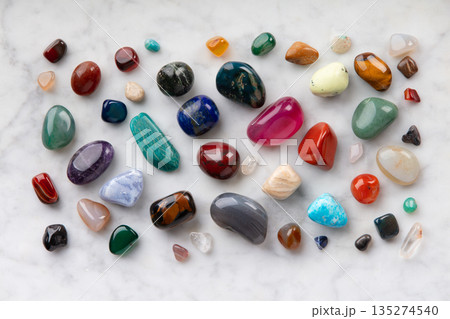 Colorful Tumbled Gemstones on White Marble Background 135274540