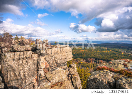 Visitors enjoy breathtaking views from the lookout points of Southern Terraces in Stolowe Mountains National Park, Poland during the autumn season. The colorful foliage enhances the scenery. Visitors enjoy breathtaking views from the lookout points of Southern Terraces in Stolowe Mountains National Park, Poland during the autumn season. The colorful foliage enhances the scenery. 135274681