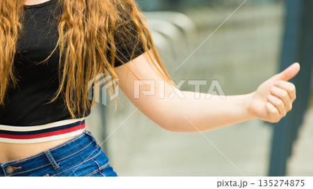 Unrecognizable woman showing thumbs up 135274875