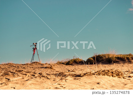 Camera on sand beach taking picture film Camera on sand beach taking picture film 135274878