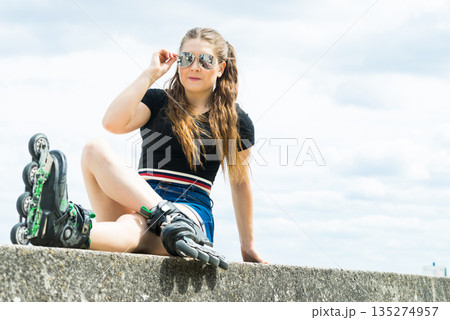 Fit girl with roller skates outdoor 135274957