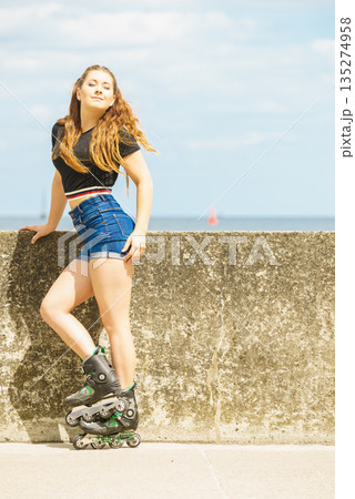 Fit girl with roller skates outdoor 135274958