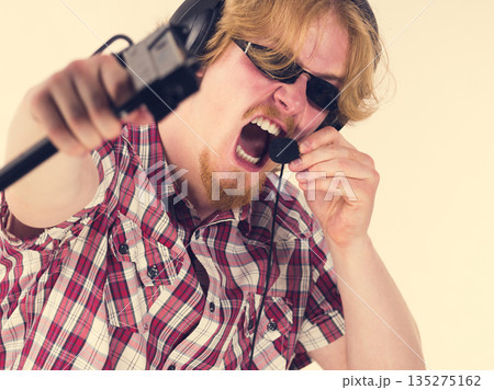 Gamer man shooting from gun Gamer man shooting from gun 135275162