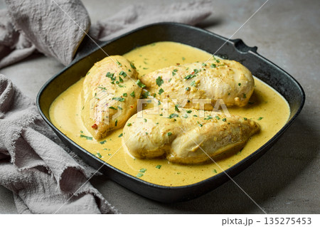 delicious chicken breast meat with creamy sauce on cooking pan delicious chicken breast meat with creamy sauce on cooking pan 135275453