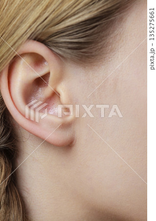 Close up on female ear and braid hair 135275661