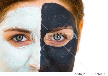 Girl with black white mud mask on face Girl with black white mud mask on face 135276033