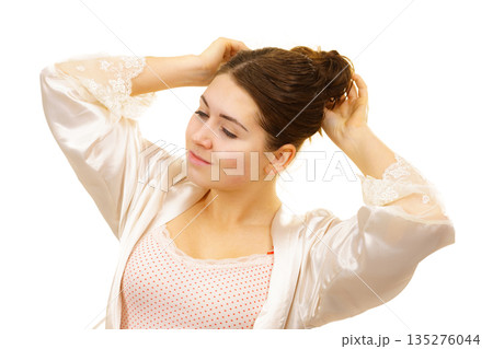 Girl with no makeup unties her hair 135276044