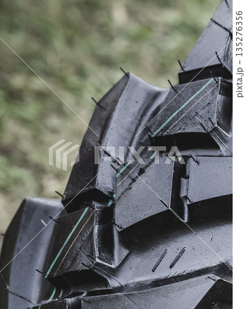 Detailed closeup of rubber tire wheel surface. 135276356