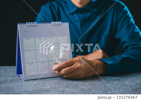 Creative job search light bulb career hire recruitment concept shows person holding glass bulb for employment opportunity near calendar, planning contemporary business success Creative job search light bulb career hire recruitment concept shows person holding glass bulb for employment opportunity near calendar, planning contemporary business success 135276467