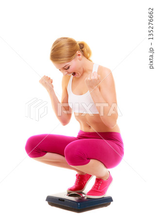 Happy successful woman weighing scale. Dieting. Happy successful woman weighing scale. Dieting. 135276662