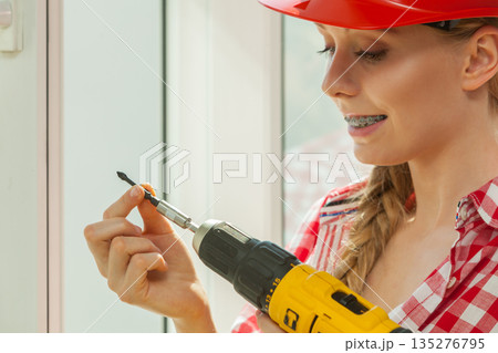 Young woman adjusting her drill 135276795