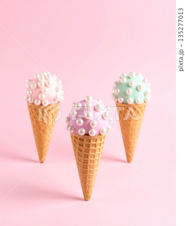 Isolated strawberry scoop of creamy pink ice cream in a crisp waffle cone dessert on a white background Isolated strawberry scoop of creamy pink ice cream in a crisp waffle cone dessert on a white background 135277013