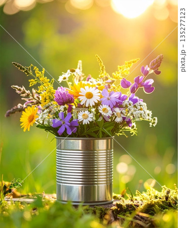 A beautiful bouquet of summer daisies blossoms in a rustic bucket and glass vase set against a bright blue sky and lush green meadow A beautiful bouquet of summer daisies blossoms in a rustic bucket and glass vase set against a bright blue sky and lush green meadow 135277123