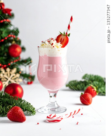 A fresh pink strawberry milkshake in a glass topped with whipped cream and a red berry garnish makes a sweet cold fruit beverage or healthy yogurt smoothie dessert isolated on white A fresh pink strawberry milkshake in a glass topped with whipped cream and a red berry garnish makes a sweet cold fruit beverage or healthy yogurt smoothie dessert isolated on white 135277347