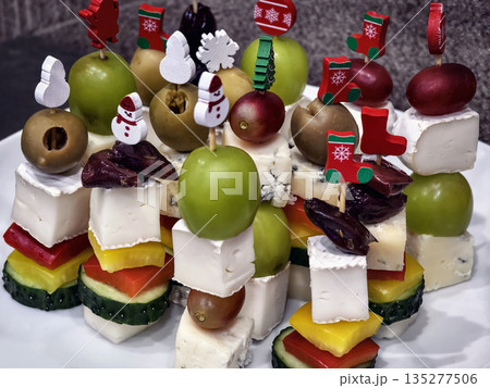 Holiday canape snacks with fruits, vegetables, and cheese arranged on a platter 135277506