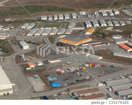 Industrial airport service zone seen from above. Logistics facilities, operational planning, and transport infrastructure through aerial perspective 135279183
