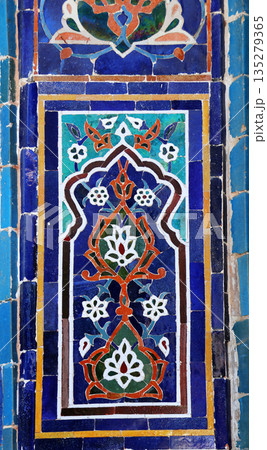 Vertical background with detail of ancient mosaic walls with floral and geometric ornament. Traditional tile decoration on wall, Samarkand, Uzbekistan Vertical background with detail of ancient mosaic walls with floral and geometric ornament. Traditional tile decoration on wall, Samarkand, Uzbekistan 135279365