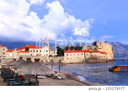 Old town, fortress wall and Adriatic sea, Budva, Montenegro. Beautiful scene with medieval houses and seascape. Topic of summer vacation, travel, cruises, tour 135279377