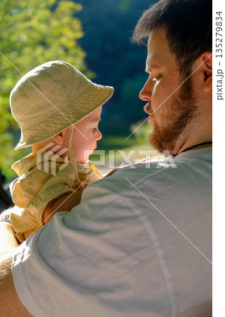 Father and Baby Relaxing in Sunny Park 135279834