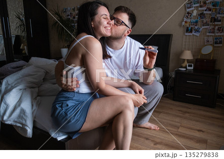 Happy Couple Celebrating Positive Pregnancy Test 135279838