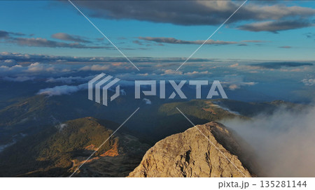 Amazing rocky mountains in clouds at sunset 135281144