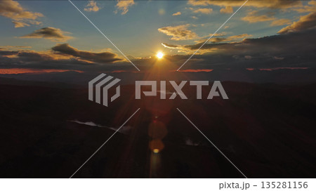Amazing rocky mountains and sun at sunset Amazing rocky mountains and sun at sunset 135281156