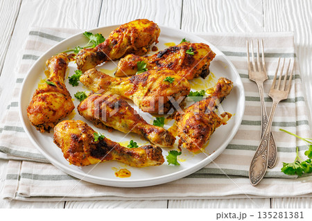 roasted chicken drumsticks on a white plate roasted chicken drumsticks on a white plate 135281381