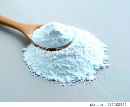 Home cleaning concept. Pile of powdered detergent with a wooden spoon on a white background. Home cleaning concept. Pile of powdered detergent with a wooden spoon on a white background. 135282233
