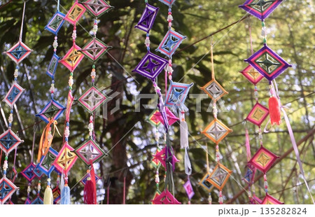 Colorful Square Spiderweb Flags in Thai Buddhist Ritual 135282824