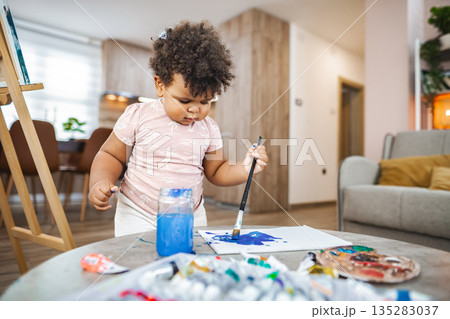 Young artist creating in afternoon light at home 135283037