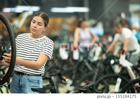 Young woman choosing bike in store 135284175