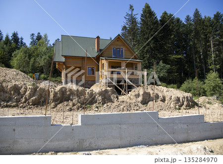 Construction of a wooden cottage in the forest area 135284970